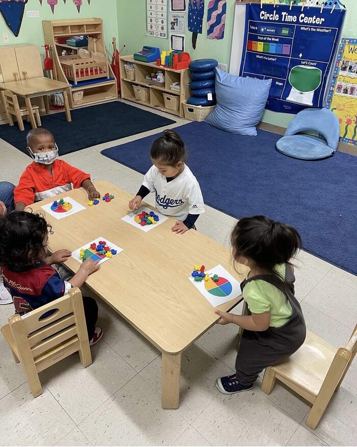 Preschoolers doing a color sorting activity together