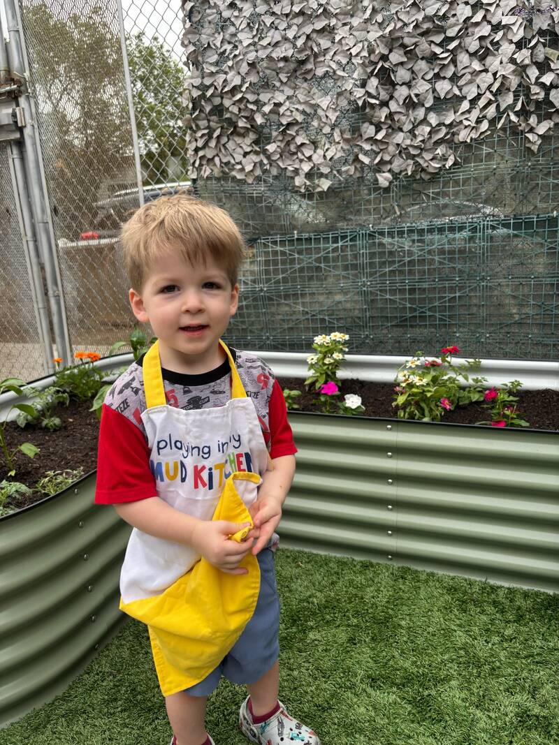 Child quietly exploring the garden at Sunny West