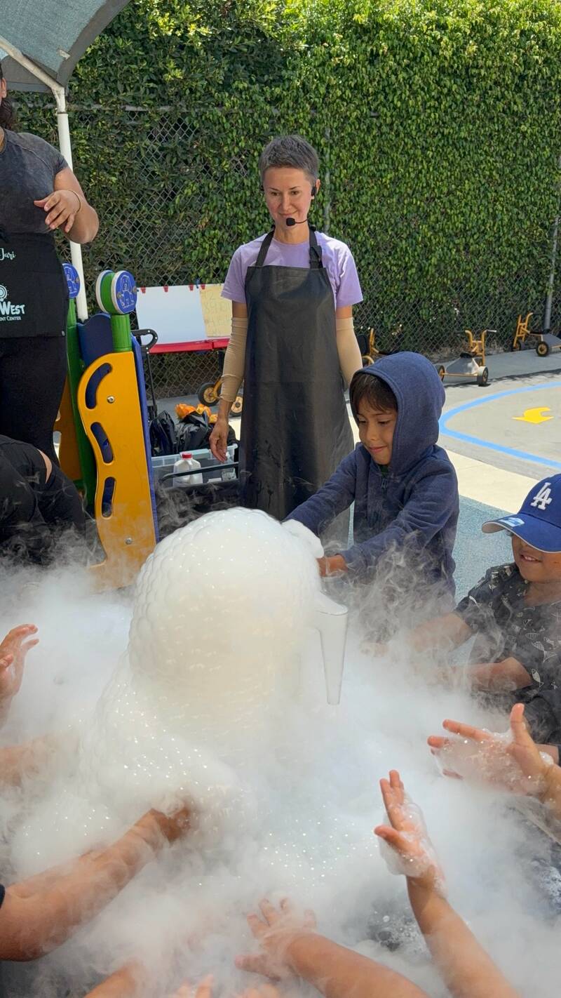 Preschooler engaged in a hands-on STEM activity at Sunny West