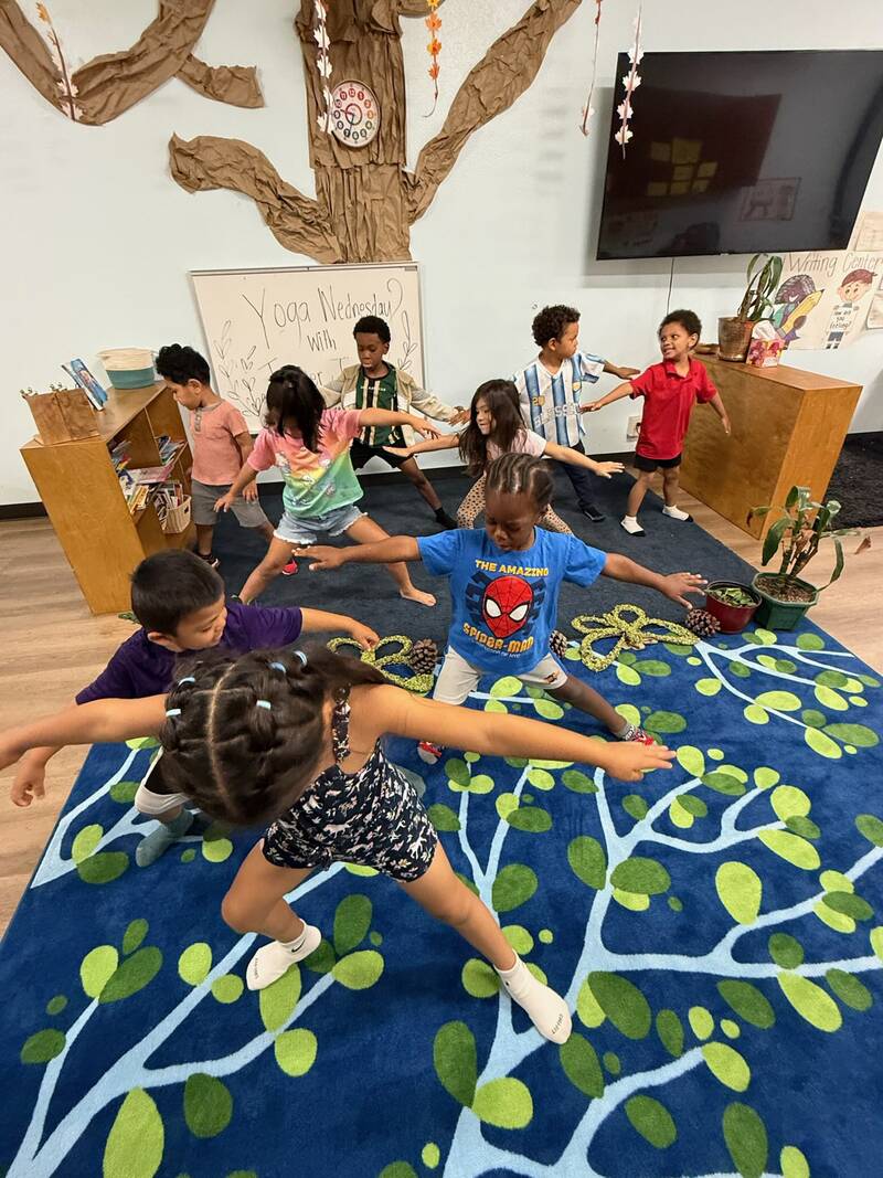 Children doing yoga together at Sunny West on Yoga Wednesday